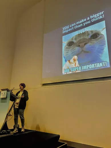 Photo of Kristina Devochko on stage at KubeCon and CloudNativeCon Europe 2023 presenting her session on sustainability in Kubernetes